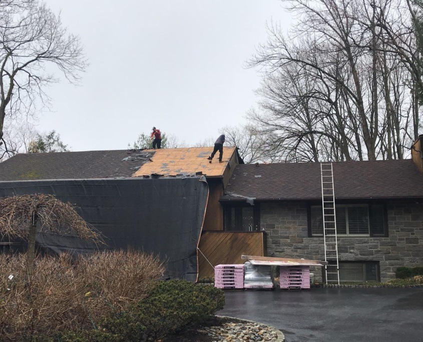 Roofers replacing roof with gaf shingles